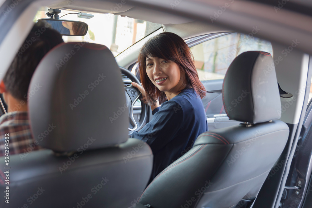 woman sit rear in car looking over her shoulder while driving travel. woman sit rear in car looking over her shoulder while driving travel.