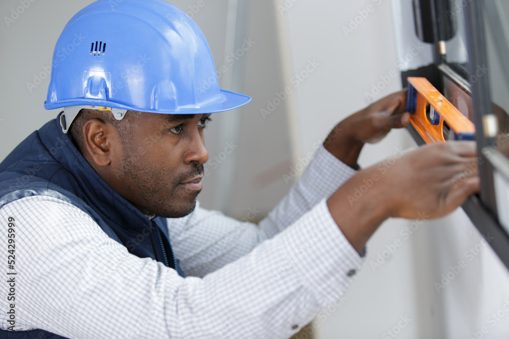 worker checks the level of a window worker checks the level of a window