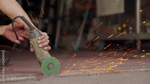 Close up of Electric grinding wheel smooths steel and iron. Spark from hot metal. Slow Motion 120 fps.