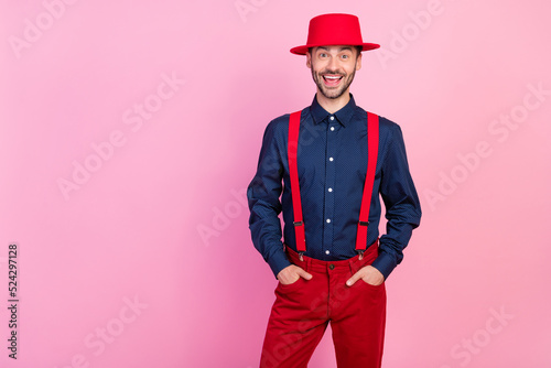 Portrait of excited satisfied man put hands pockets empty space ad isolated on pink color background © deagreez