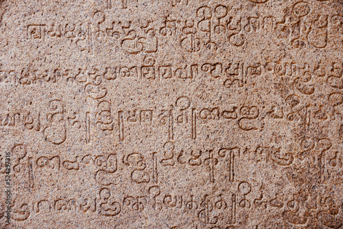 Inscriptions of ancient language carved on the stone walls at Hindu temple in Mahabalipuram, Tamilnadu, India. Ancient tamil inscriptions carved in the exterior temple walls in Mahabalipuram.