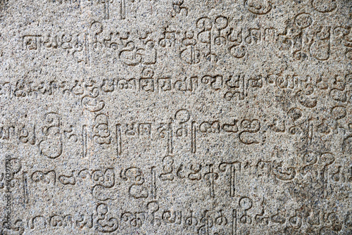 Inscriptions of ancient language carved on the stone walls at Hindu temple in Mahabalipuram, Tamilnadu, India. Ancient tamil inscriptions carved in the exterior temple walls in Mahabalipuram.