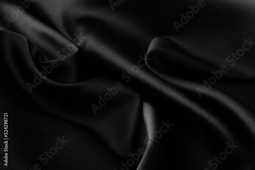 Folds of black silk fabric.