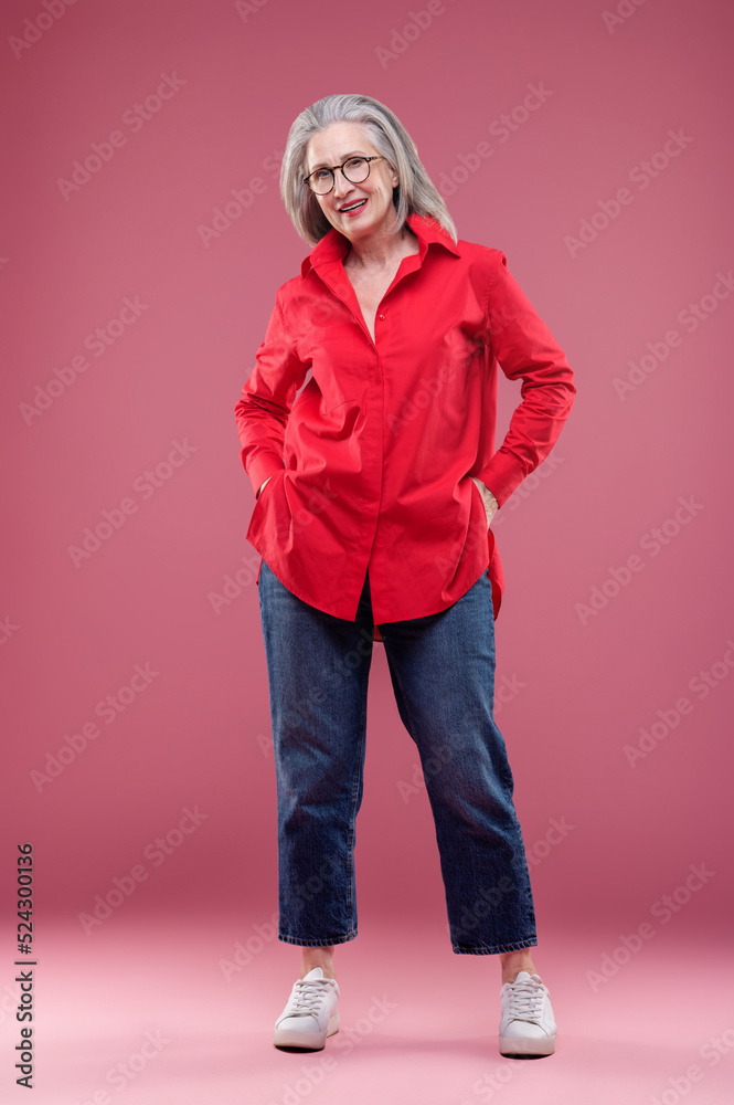 Mature woman in red shirt looking contented Mature woman in red shirt looking contented