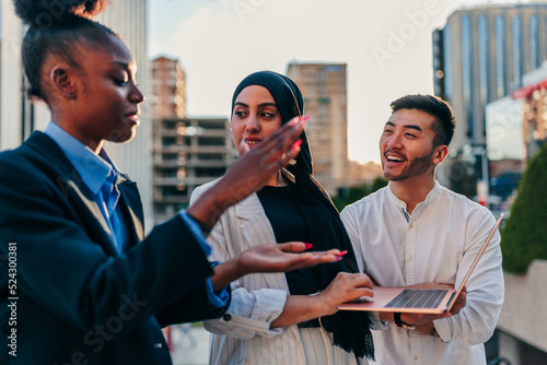 Businesspeople working on computer in urban area