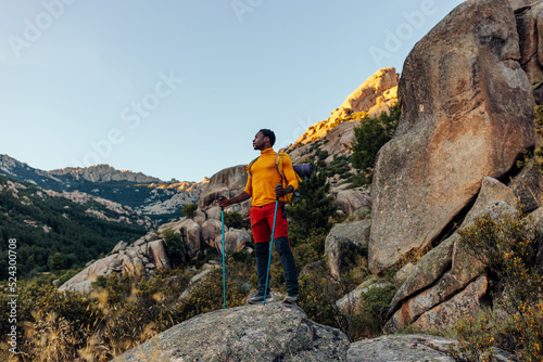Hiker standing under mountain summit