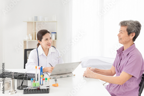 doctor talk with patient in mental health clinic, she screening and write patient information on patient chart, elderly healthcare promotion