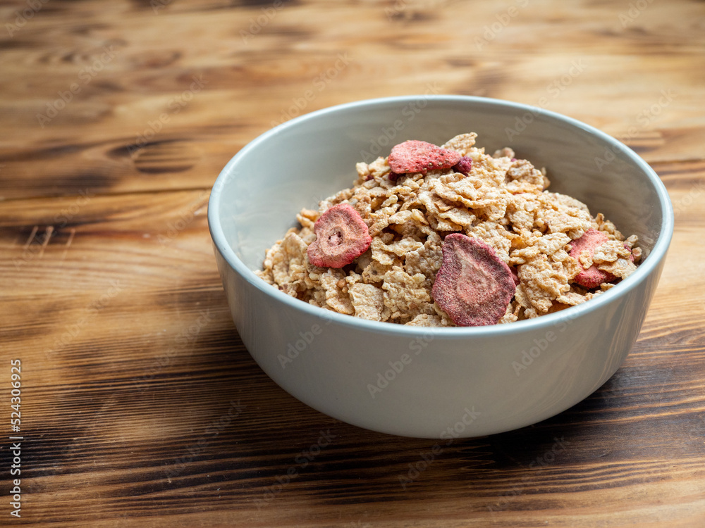 A cup with muesli and fresh berries on a wooden table. Healthy food, snack or breakfast. A cup with muesli and fresh berries on a wooden table. Healthy food, snack or breakfast.