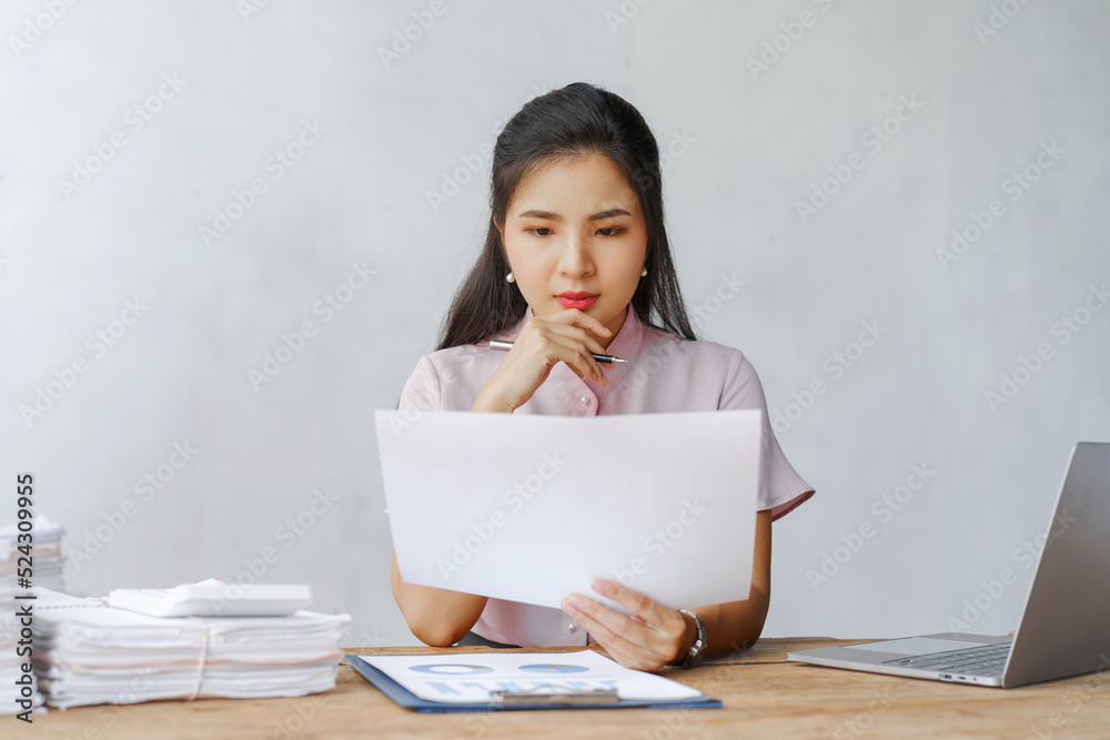 Beautiful young attractive Asian woman office worker working in office. Beautiful young attractive Asian woman office worker working in office.