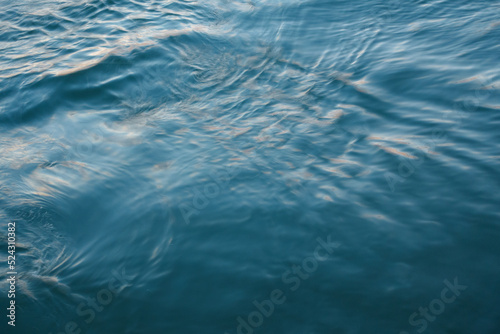 Abstract background  the blue sea lit by the evening sun