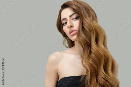 Portrait of a beautiful brunette with long wavy hair. Copycpase