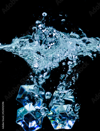 ice cubes in water with bubbles on black background © STOCK PHOTO 4 U