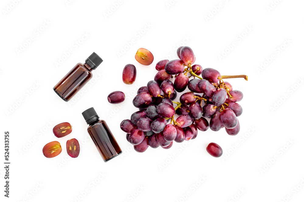 Obraz premium Grape seed oil in bottles with bunch of grapes. Eco cosmetic product