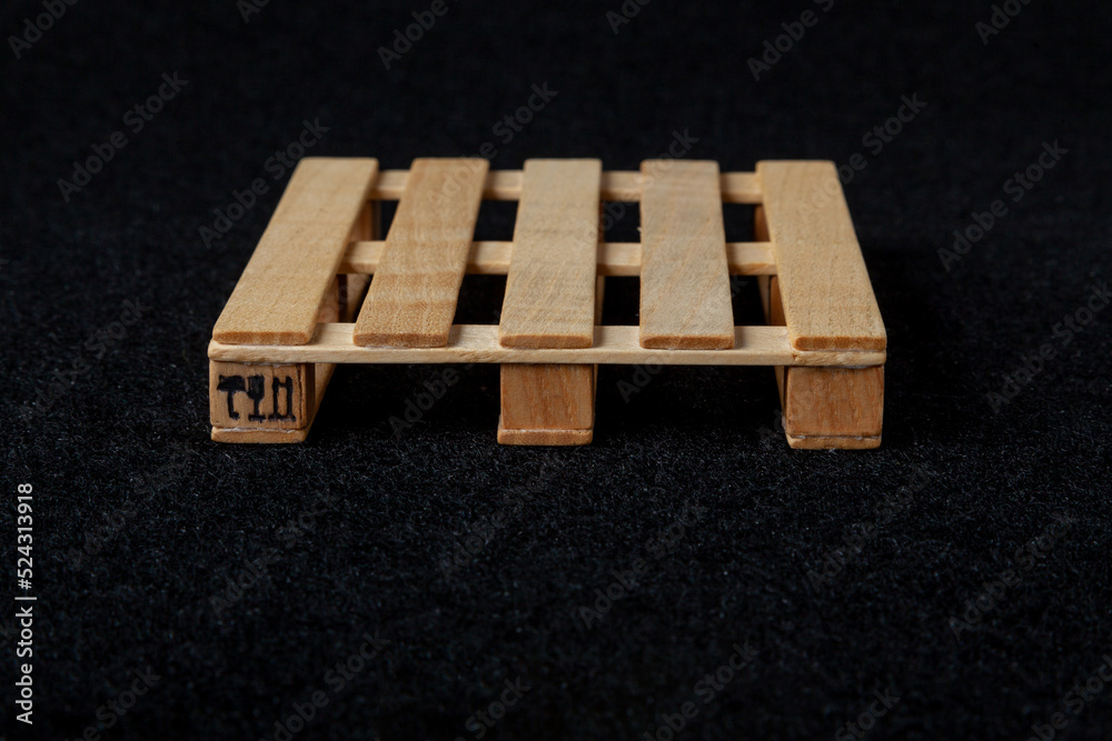 Reduced model wooden euro pallet on black felt background.... Reduced model wooden euro pallet on black felt background....