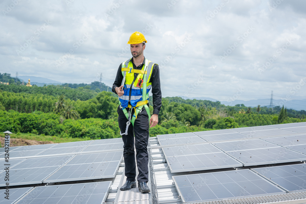Engineer working and maintenance with solar batteries near solar panels at sunny day on roof structure of building factory,Alternative energy to conserve the world's energy. Engineer working and maintenance with solar batteries near solar panels at sunny day on roof structure of building factory,Alternative energy to conserve the world's energy.