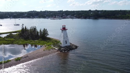 Circular aerial drone footage of the Kidston Island Lighthouse in Baddeck, Nova Scotia photo