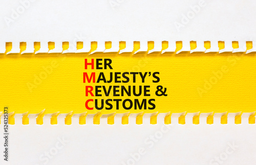 HMRC her majestys revenue and customs symbol. Concept words HMRC her majestys revenue and customs on beautiful white and yellow background. Business HMRC revenue and customs concept. Copy space. photo