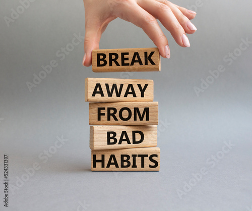 Break away from bad habits symbol. Wooden blocks with words Break away from bad habits. Beautiful grey background. Businessman hand. Business and Break away from bad habits concept. Copy space.
