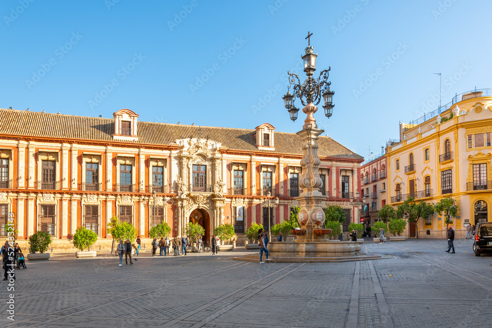 The Plaza Virgen de los Reyes with tourists and locals on an autumn morning in the Barrio Santa Cruz district of Sevilla.