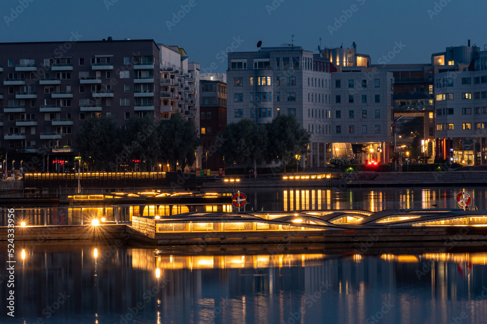 Stockholm, Sweden Illuminated swimming platforms at night in the Liljeholmskajen district.