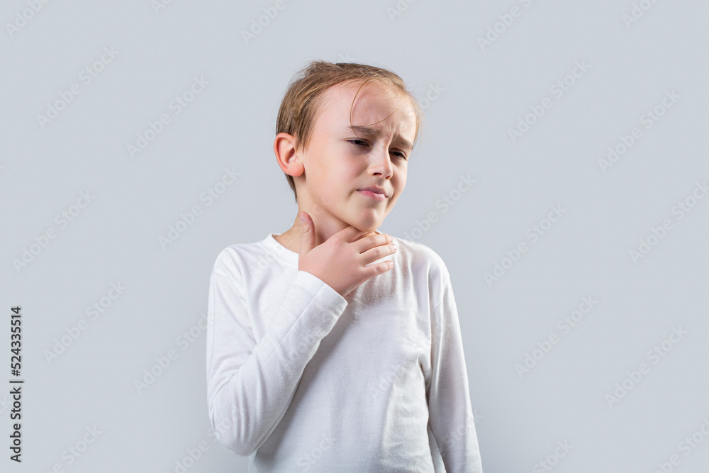Young boy feels that his throat is pain. Ill little boy with sore throat. Ill child with sore throat. Sore throats in a child. Child has a sore throats. Signs of a cold in children Young boy feels that his throat is pain. Ill little boy with sore throat. Ill child with sore throat. Sore throats in a child. Child has a sore throats. Signs of a cold in children