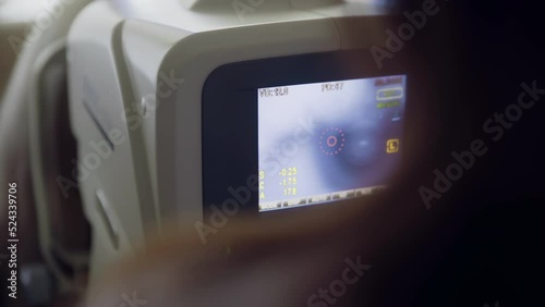 4K. A close-up of the eye is examined on a modern computer-controlled autorefractor.