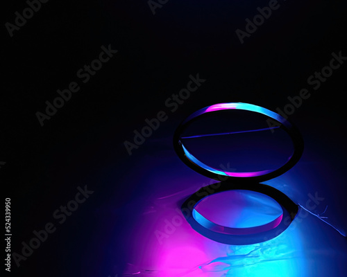 light rings, pink and blue, magenta and turquoise with reflections on the floor, black background, moving light rings