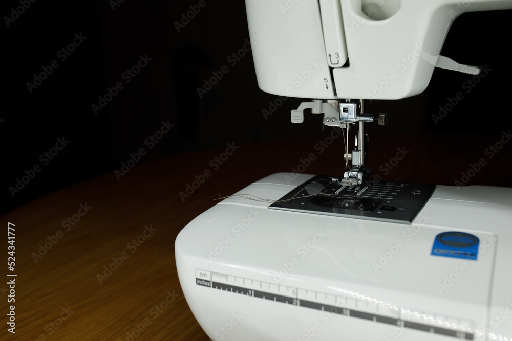 white sewing machine on a wooden table work