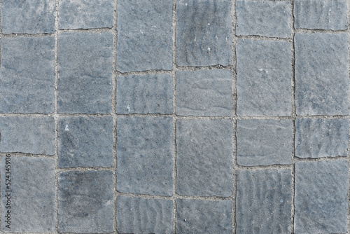 An abstract image of grey concrete patio tiles. 