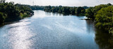 Panorama rzeki Odry w tle lekko pochmurna pogoda, błękit nieba zieleń przy brzegu, pora letnia, Odra w odcinku województwa Opolskiego