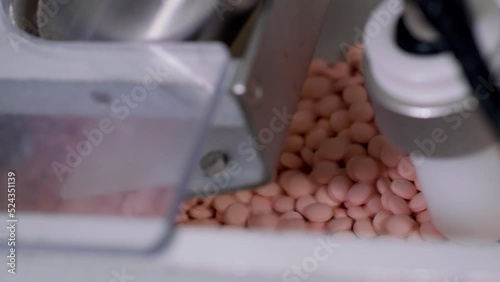 Process of production of pills, tablets. Industrial pharmaceutical concept. Factory equipment and machine.