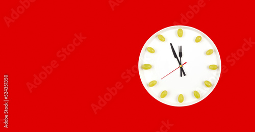 Photography Clock made of plate and grapes on red background