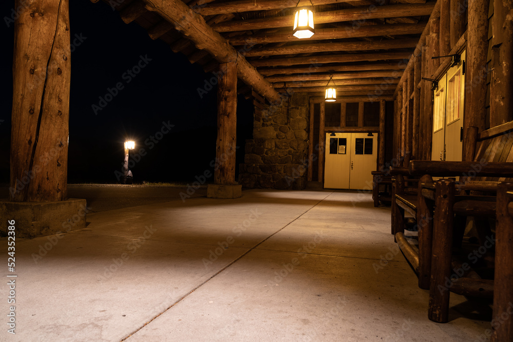 Seating outside the closed Old Faithful Lodge at night, no people in photo