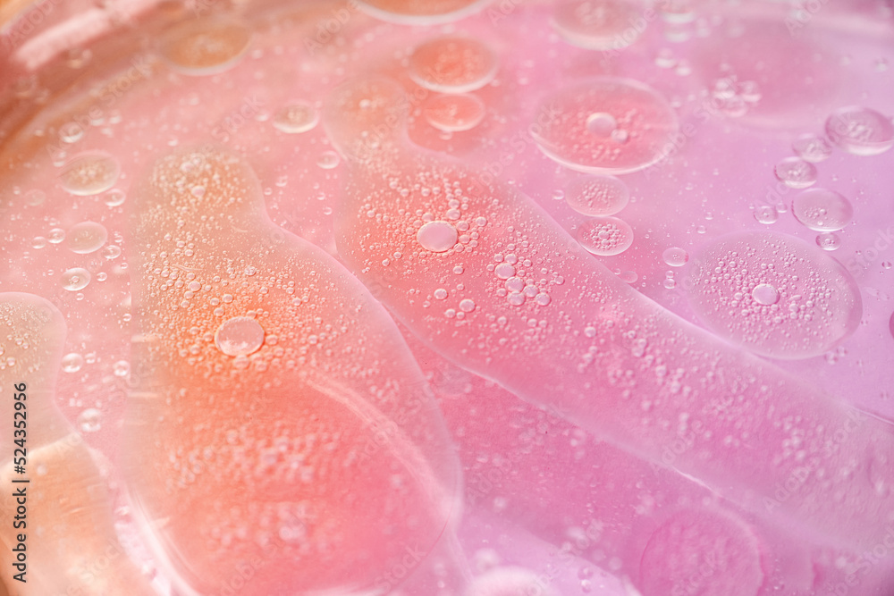 abstract pink and orange background formed by oil drops on water abstract pink and orange background formed by oil drops on water