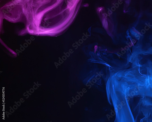 close up of colorful pink and blue steam smoke in mystical and fabulous forms on black background. Mocap for art