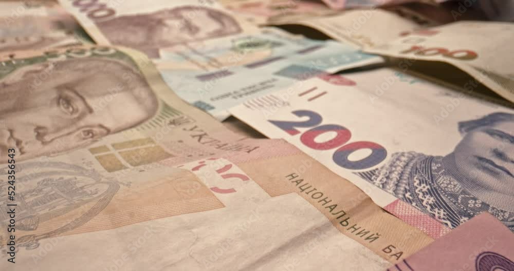 Close up shot of Ukrainian hryvnya bills. Ukrainian money banknote. Slow motion. Investment. Cash credit. UA currency. Inflation. Finance concept. Bank and banking. Many different banknotes Close up shot of Ukrainian hryvnya bills. Ukrainian money banknote. Slow motion. Investment. Cash credit. UA currency. Inflation. Finance concept. Bank and banking. Many different banknotes