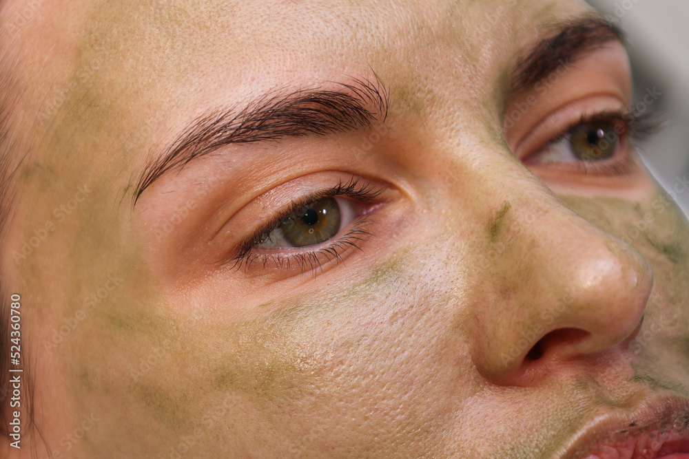 Woman patient portrait, prepared for LED phototherapy for the face. Girl with green gel with seaweed photosensitizer. Facial care. Light therapy in clinic, anti-age procedure. Face closeup Woman patient portrait, prepared for LED phototherapy for the face. Girl with green gel with seaweed photosensitizer. Facial care. Light therapy in clinic, anti-age procedure. Face closeup