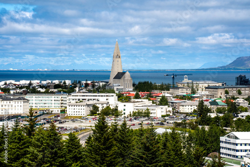 Reykjavik, Iceland - July 4, 2022 A panoramic view of the city's skyline and the iconic Hallgrímskirkja church. Seen from rooftop of the Perlan Museum during a summer day. photo