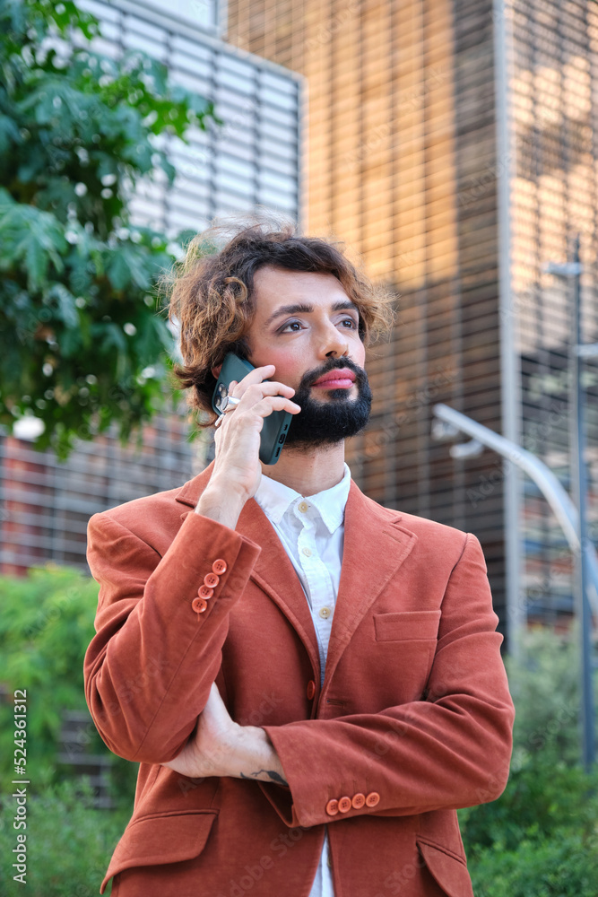 Businessman with makeup talking on the phone while standing outdoors in the financial district. Businessman with makeup talking on the phone while standing outdoors in the financial district.