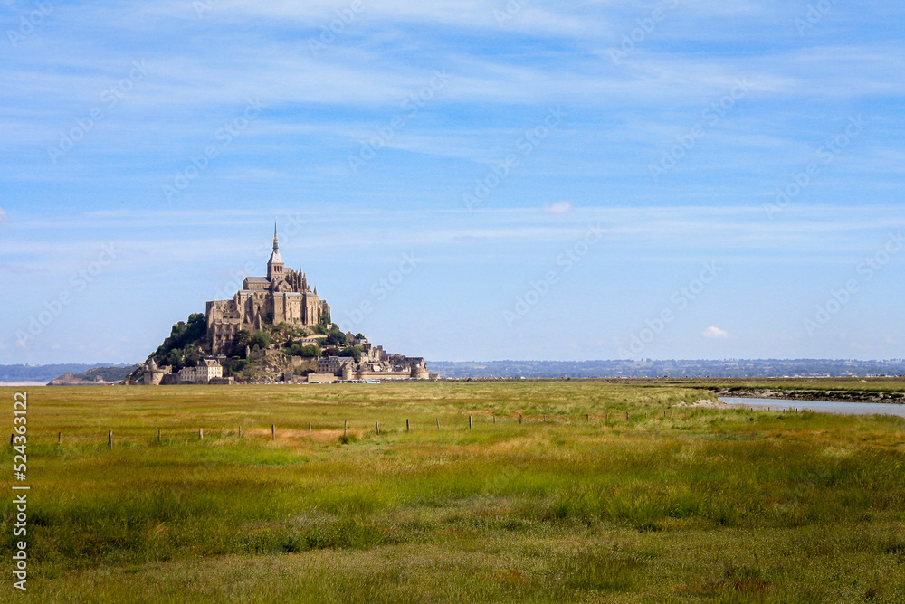 Beautiful panoramic view of famous Le Mont Saint-Michel tidal island with blue sky. Normandy, northern France Beautiful panoramic view of famous Le Mont Saint-Michel tidal island with blue sky. Normandy, northern France