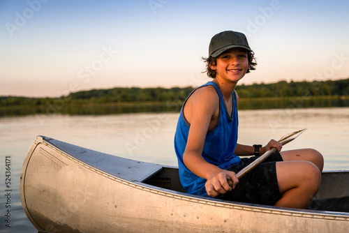 Photography Air Force service member takes his sons canoeing at sunset out on the lake