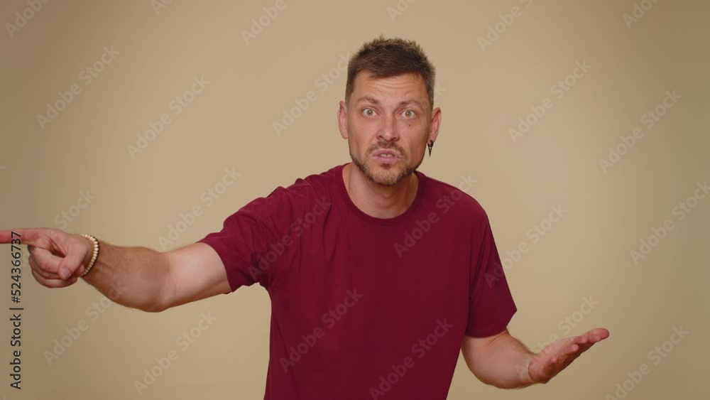 Get out of here. You are fired. Dissatisfied young man pointing finger away asking to leave his alone, strict boss firing, conflict, crisis, deadline. Adult stylish guy on beige studio wall background Get out of here. You are fired. Dissatisfied young man pointing finger away asking to leave his alone, strict boss firing, conflict, crisis, deadline. Adult stylish guy on beige studio wall background