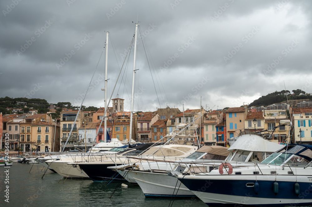 Rainy day in South of France, view on old fisherman's port with boats and colorful buildings in Cassis, Provence, France