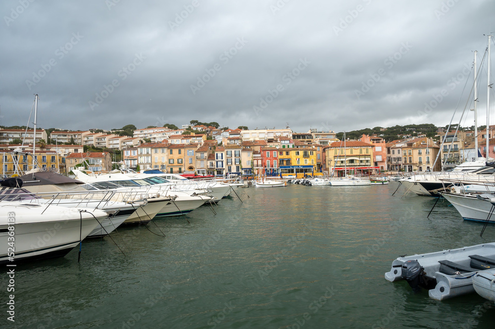 Rainy day in South of France, view on old fisherman's port with boats and colorful buildings in Cassis, Provence, France