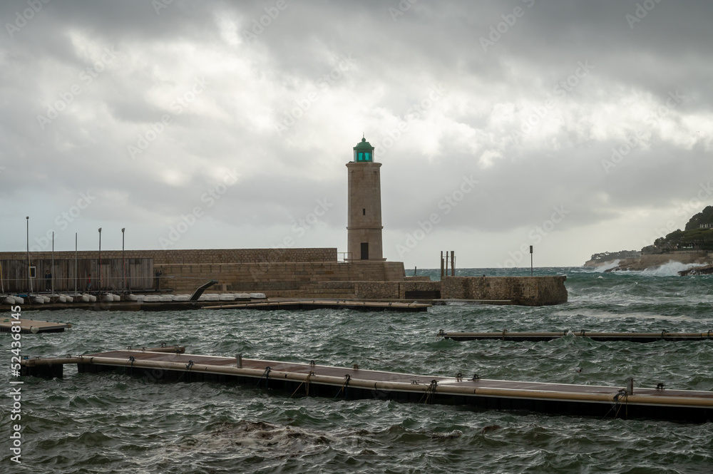 Stormy sea, high waves in old fisherman's harbour with lighthouse in Cassis, Provence, France