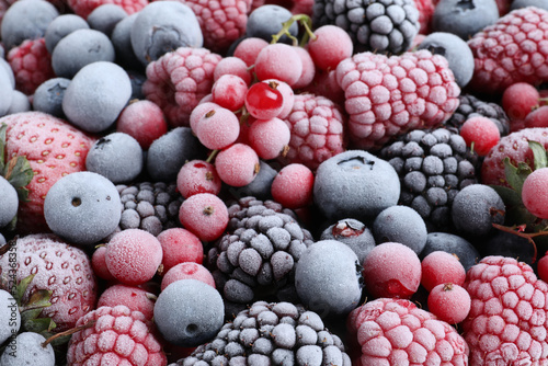 Mix of different frozen tasty berries as background, closeup