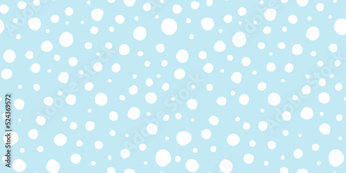 Seamless playful hand drawn light blue and white polka dot, snow or animal spots fabric pattern. Abstract geometric circle background texture. Boy's birthday, baby shower or nursery wallpaper design.
