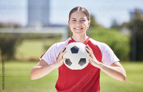 Soccer player, ball and young woman happy to play a fun sports game in a practice stadium field in summer. Exercise, training and workout of a healthy, fitness and athlete smiling on a grass pitch © Alex S/peopleimages.com