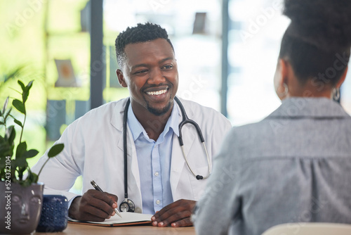 Doctor talking to patient in medical consultation, checkup and visit in a clinic, hospital and healthcare center. Professional, gp and frontline worker listening and writing prescription medication photo