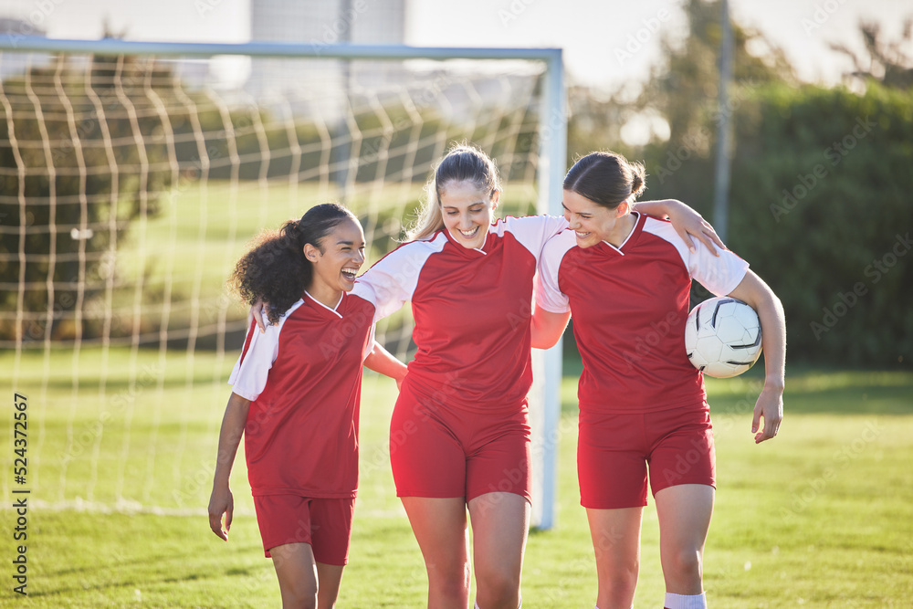 Fun female football players or friends in sportswear hugging, smiling and bonding together after practicing on a field. Young, sport and athletic soccer girls talking about good and exciting match